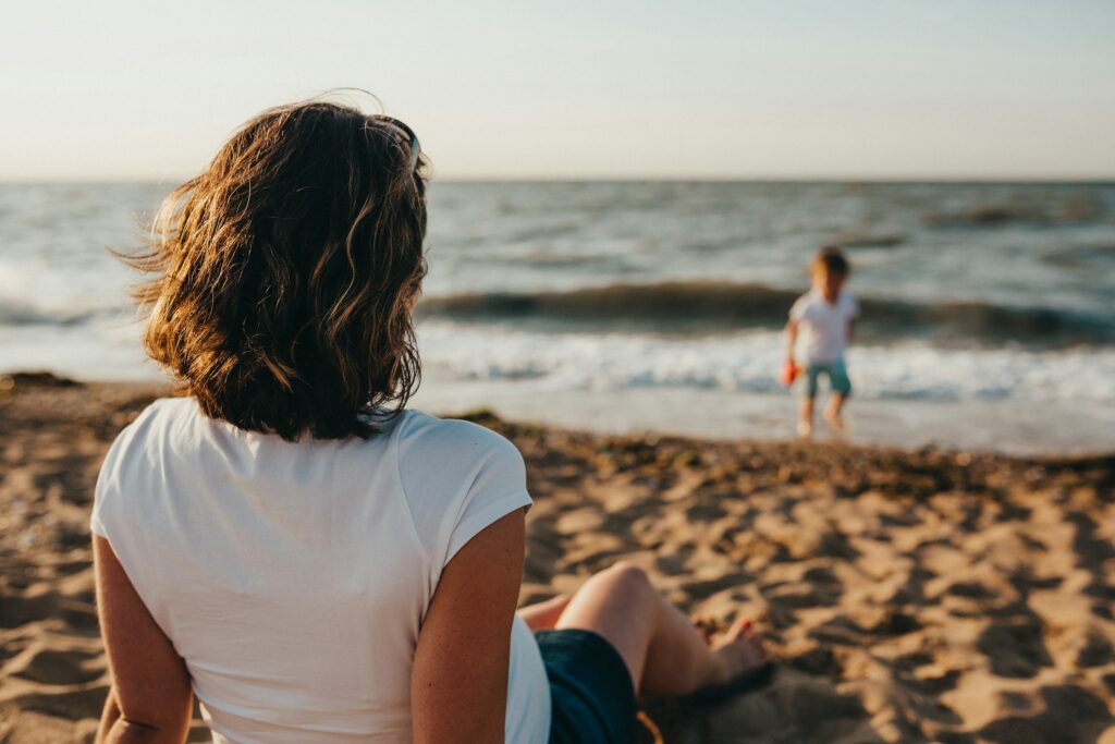 A traveller enjoys some quality time with her family on the beach