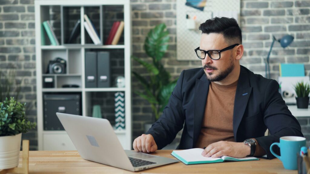 A vacation rental manager checks guest messages from their laptop.