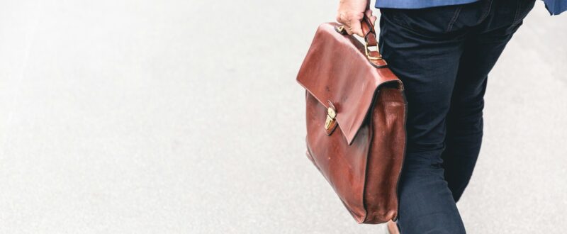 A business traveler walking to their hotel booked via a GDS